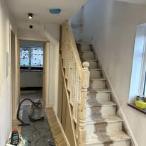 Finished hallway with new timber staircase and painted walls