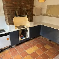 Kitchen renovation with new dark cabinets and white worktops in progress