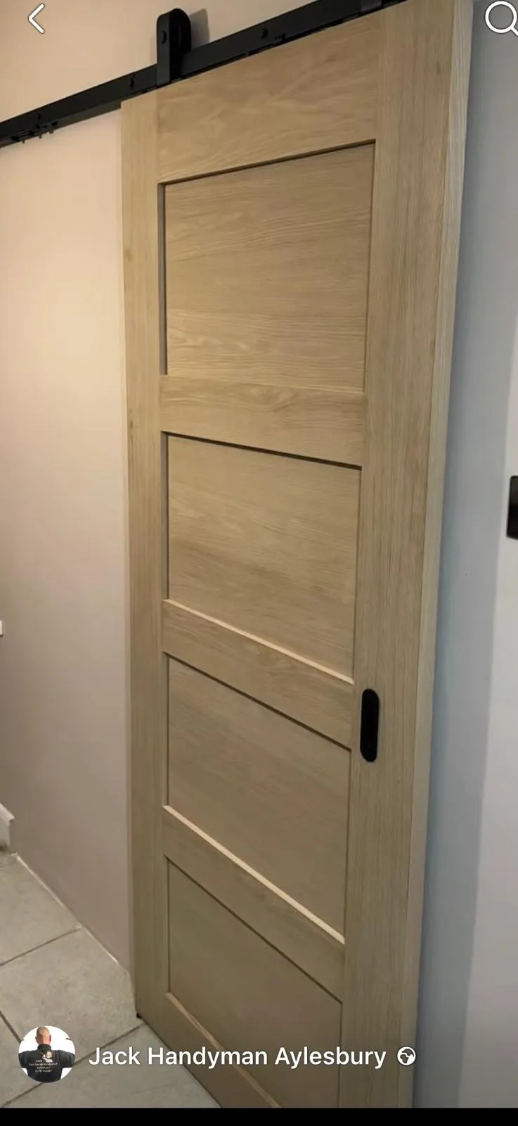 Oak internal sliding door fitted on a black rail by Jack Handyman Aylesbury