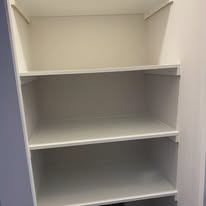 White wardrobe shelving with a hanging rail above for practical internal storage