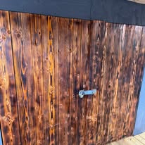 Timber shed with a neatly fitted door as part of an outdoor timber project