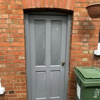 Grey glazed front door repainted with brass handle and letterplate