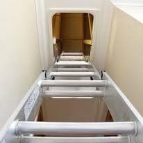 Aluminium loft ladder extended through a ceiling hatch
