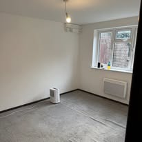 Freshly decorated room after renovation with clean walls and prepared floor