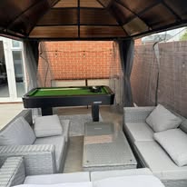 Assembled outdoor sofas and coffee table inside a completed garden gazebo