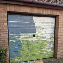 Garage door half painted showing preparation and repainting in progress