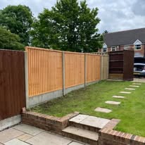 New wooden fence panels with concrete posts and a matching garden gate