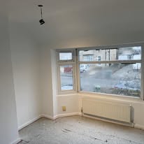 Bright bay-window room prepared and finished during an interior renovation