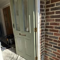 Exterior front door prepared indoors before repainting