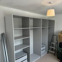 Fitted white wardrobe interior with shelves, rails and drawers installed in an Aylesbury home